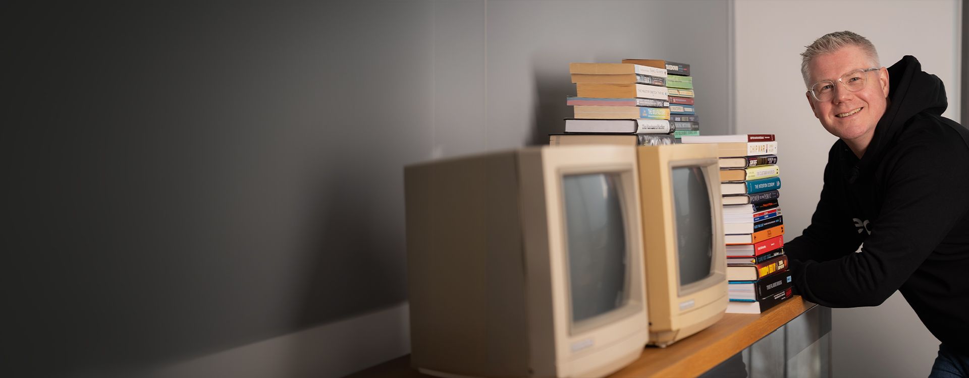 esatus AG expert in front of a bookshelf — active role in shaping digital identity standards