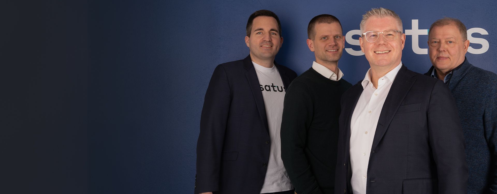 Three esatus AG team members smiling in a professional office setting